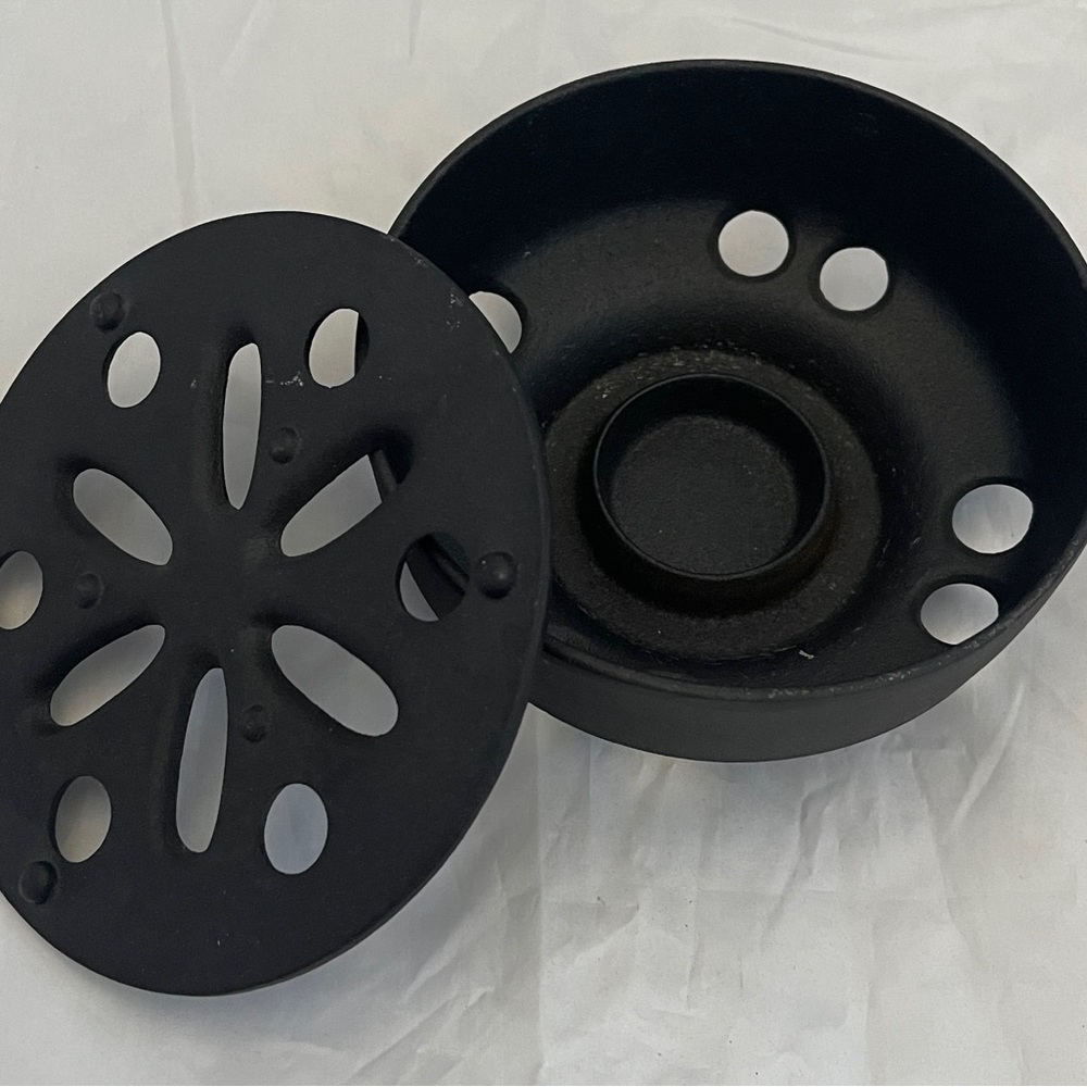 Cast Iron 2 piece candle holder. 6 in. diameter. Weight is 2 pounds, 13 ounces